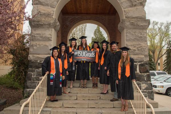 ISU graduates in front of Swanson Arch