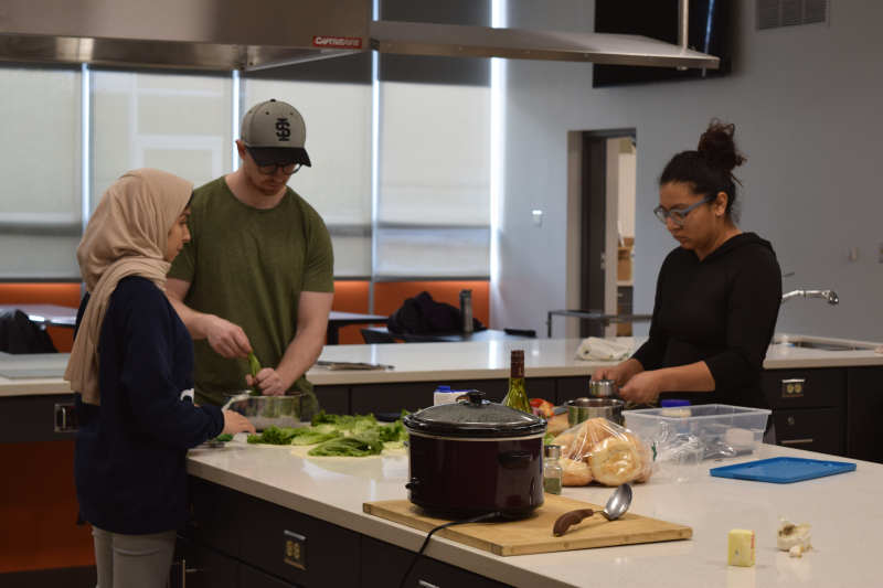 Two international students cook with in the ISU state of the art Foods Laboratory