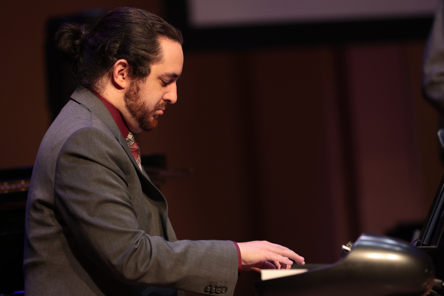 Gabe Lowman plays piano at a Jazz and Commercial Music Concert at Jensen Hall