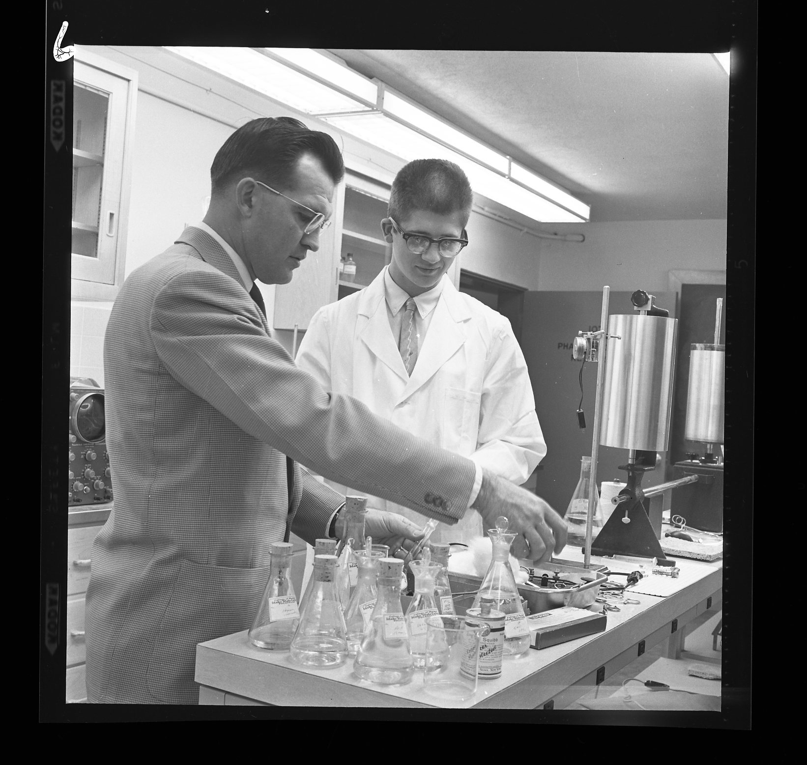 Historical photo with pharmacy dean and student in lab
