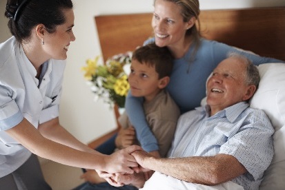 A stock image of a nurse caring for their patient and family