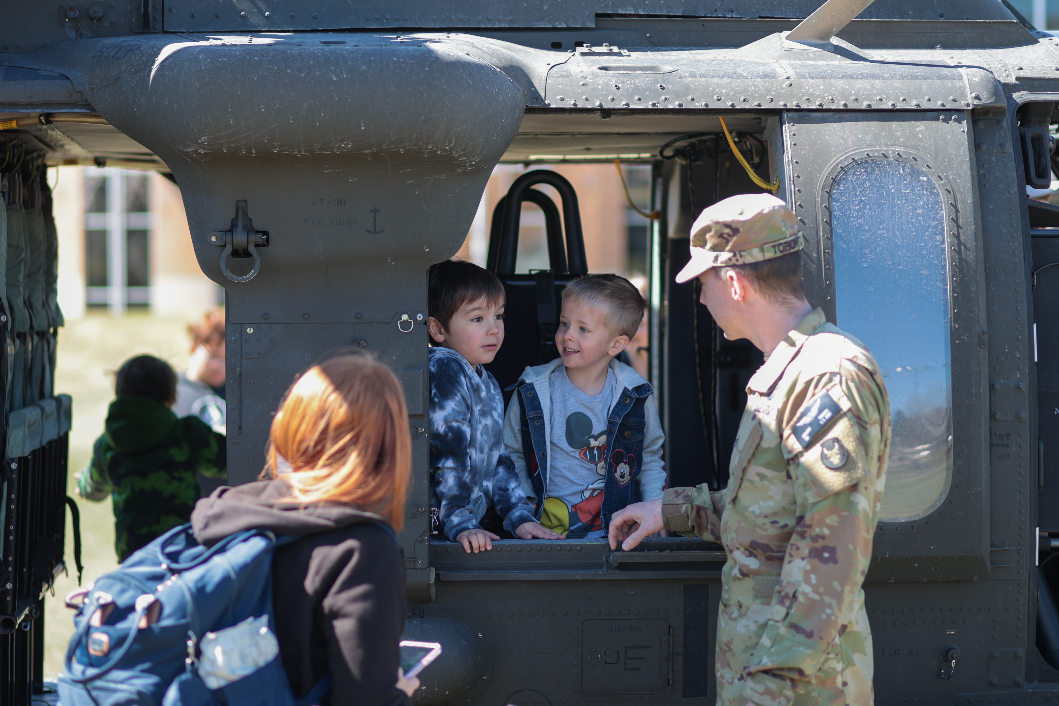 Small children enjoy a helicopter on campus at ISU