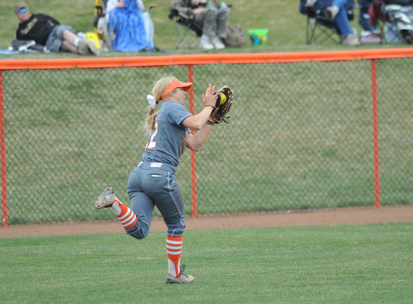 Kacie Burnett  running in centerfield catching a softball.