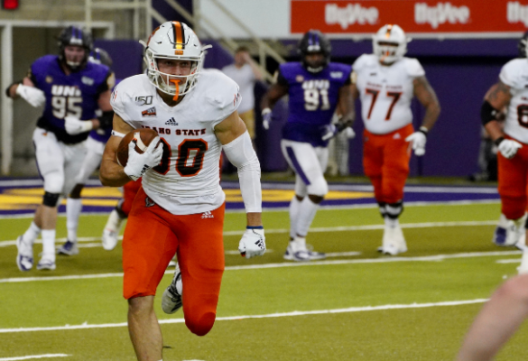 ISU Football player running with the football