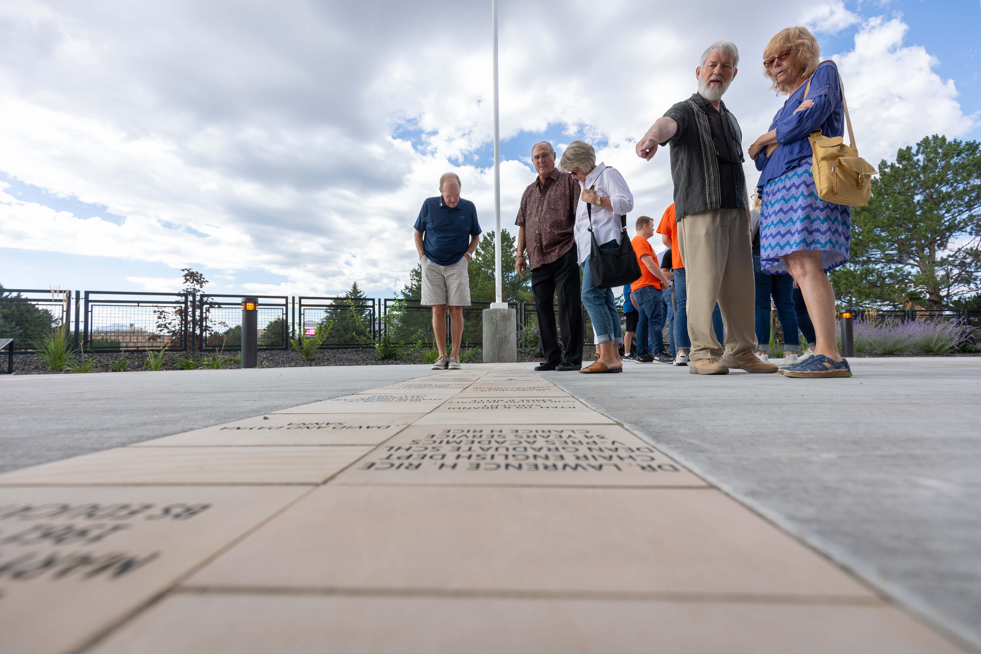 People looking at pavers outside Alumni Center