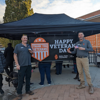 Veterans Day Donut Giveaway people in front of sign