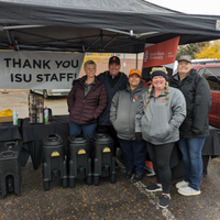 Staff members tailgating with hot chocolate giveaway