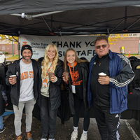 Staff council tailgate posing with hot chocolate