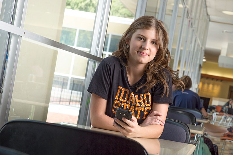 Student sitting at a table in the Student Union Building