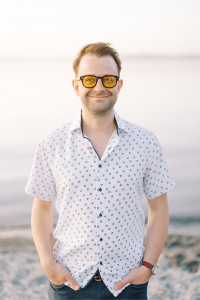 Zackary Beal stands outside on a beach