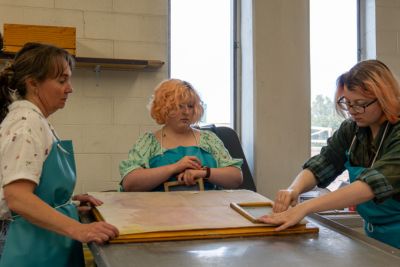 Students work on paper art projects