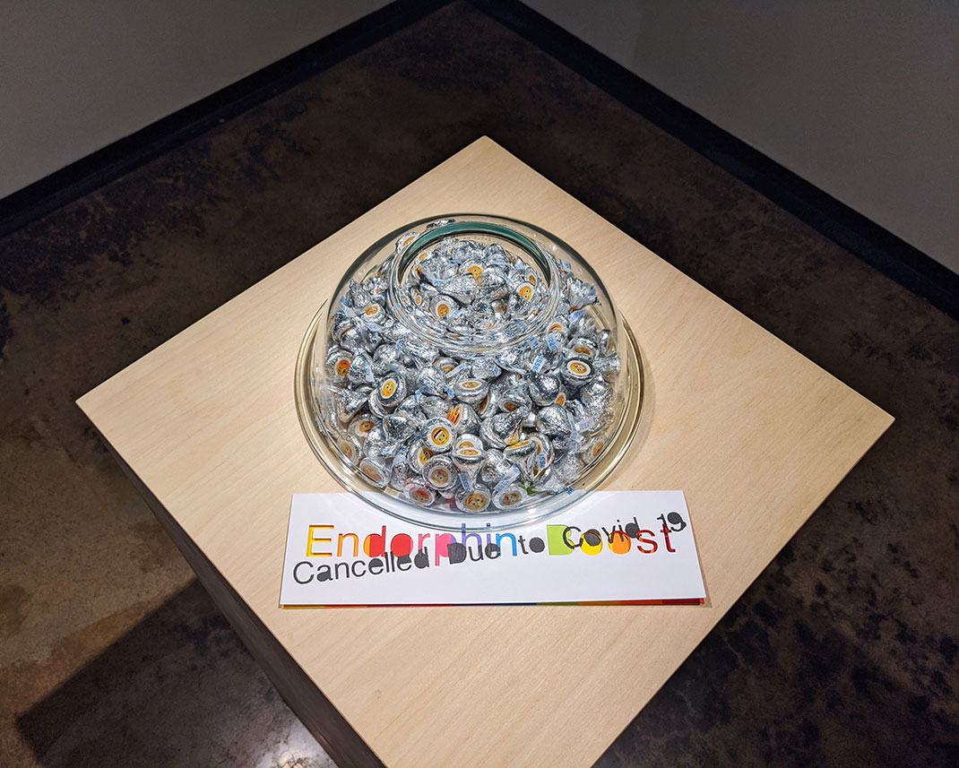 A candy dish sits on a pedestal. An accompanying card reads: 