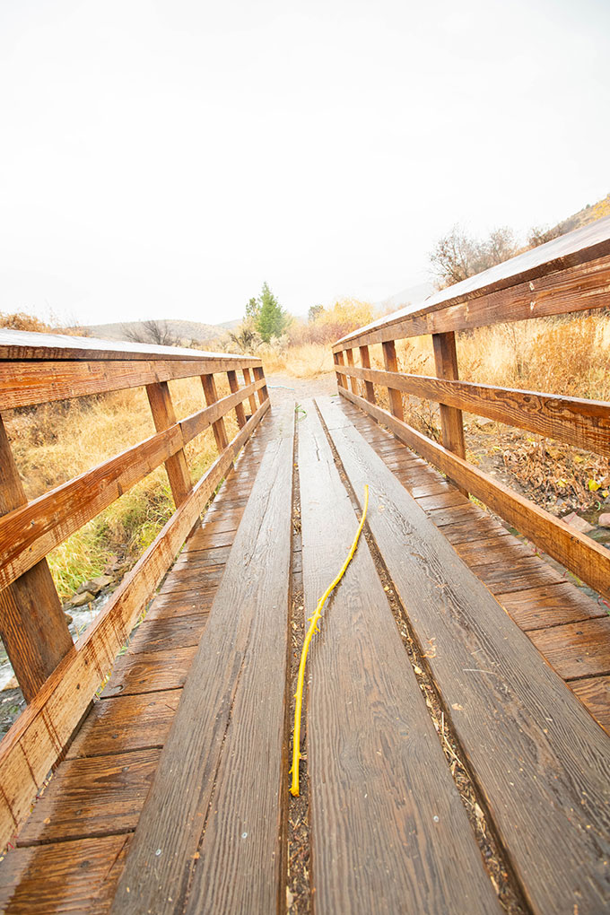 Installation photo - colorful rope laid across a bridge