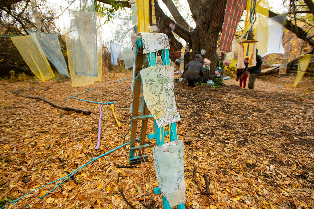 Ink drawings sewn together and draped over cyan wood planks