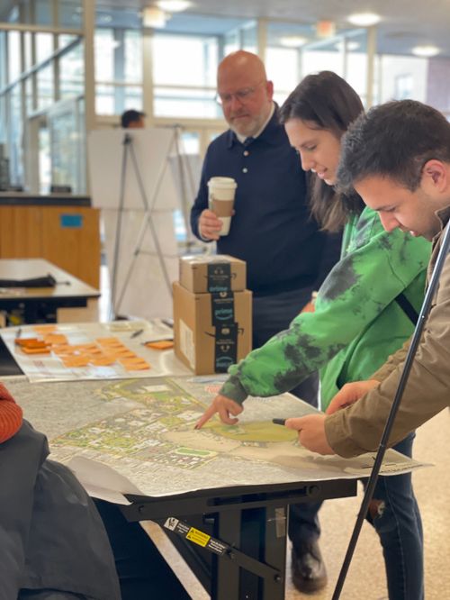 A group of people looking at a map on a table