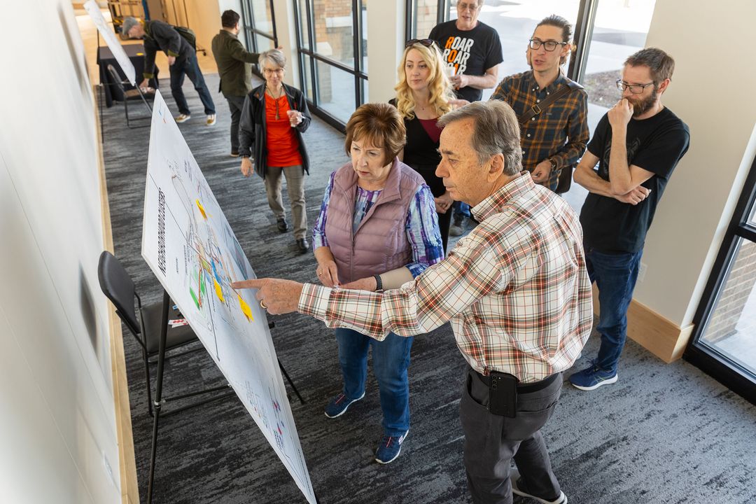 A group of people looking at a map