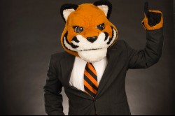 Benny Bengal in a suit pointing up