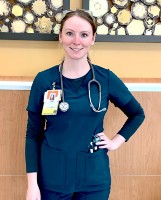 Nursing student standing next to hospital wall with stethoscope