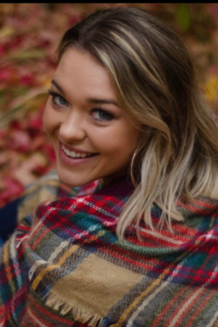 Woman smiles while sitting