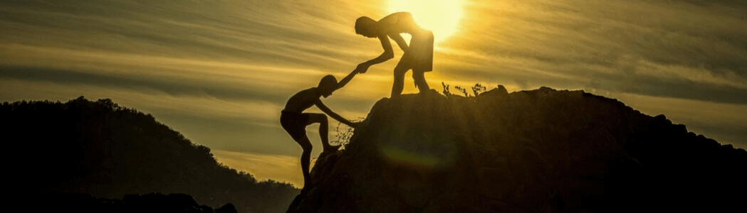 Climbers assisting each other