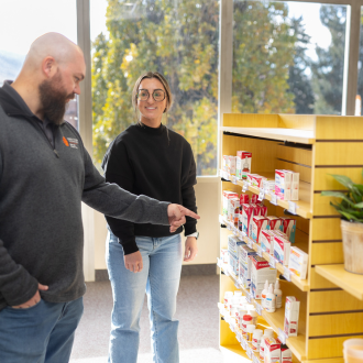 pharmacist and customer in otc section