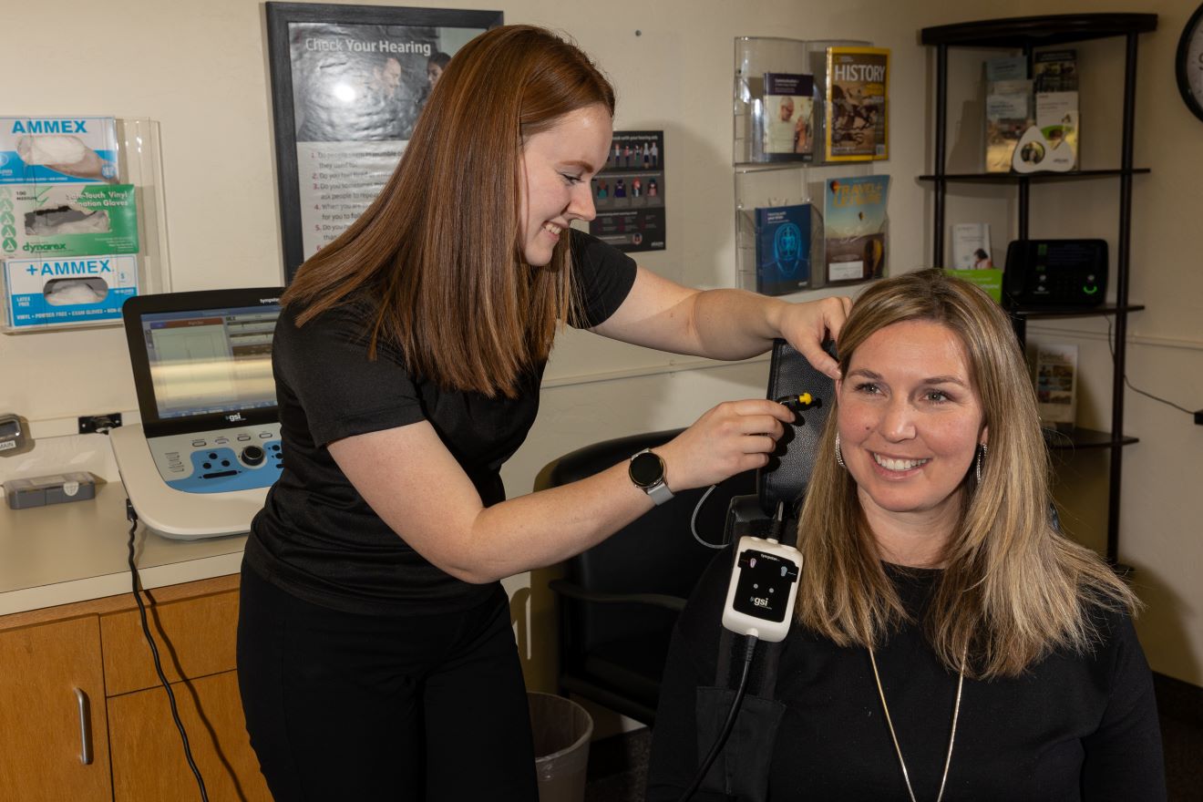 Audiology student working with a patient