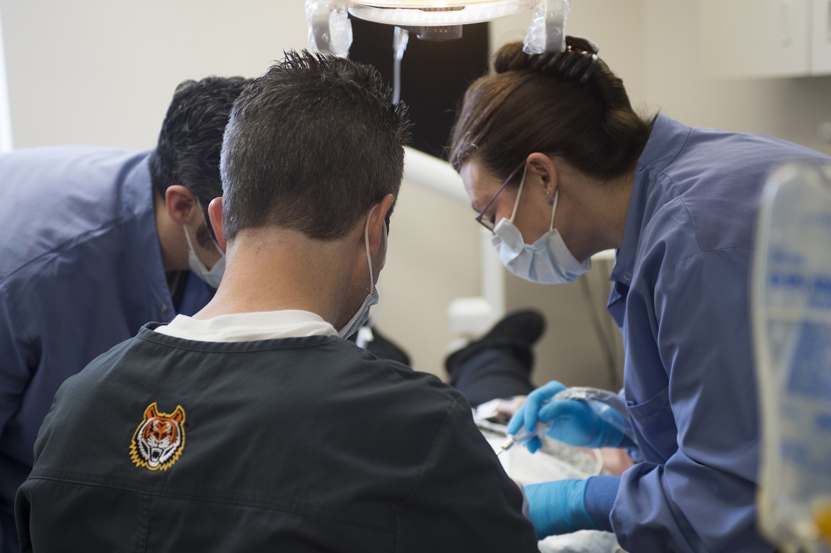 Dental Residents treating a patient.