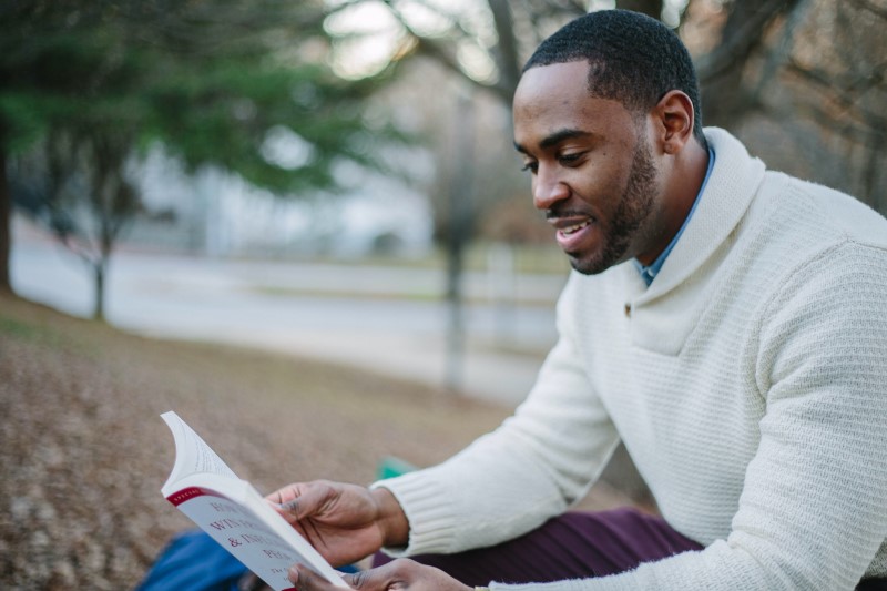 Photo of man reading an article