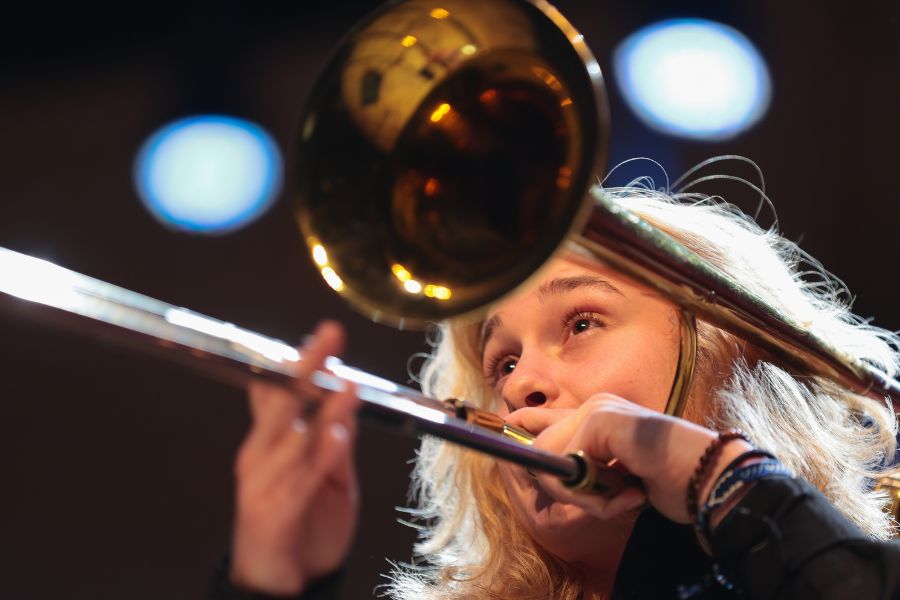Mal Layne plays her trombone on stage during an ISU jazz concert