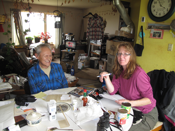 A man and woman sit at a table in Alaska.