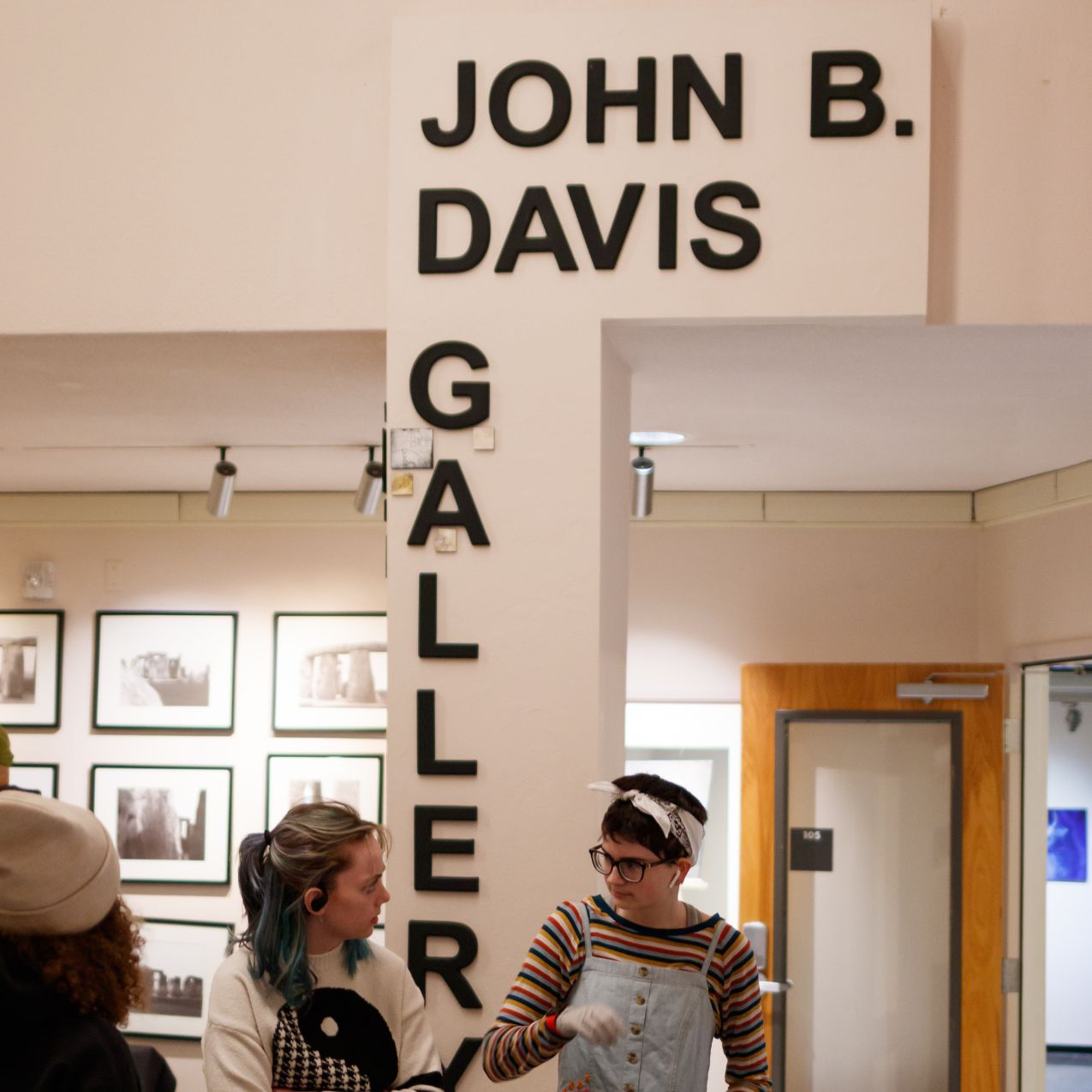 People mingle outside the entry to the John B. Davis art gallery in the Fine Arts building