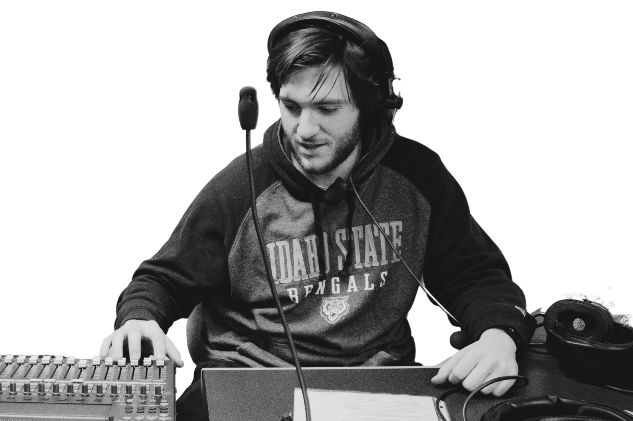 student working at a sound board with headphones on