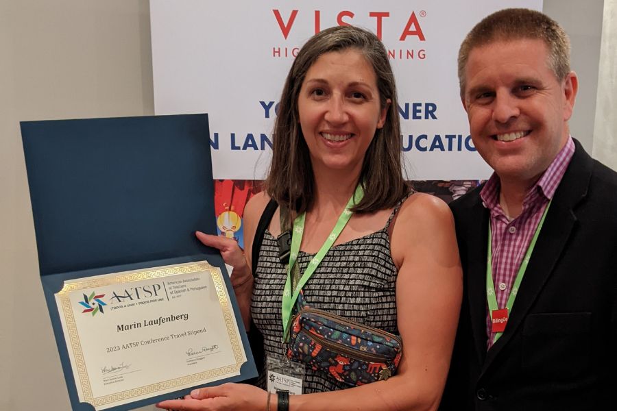 Dr. Marin Laufenberg poses with a representative from Vista Higher Learning with her AATSP award certificate