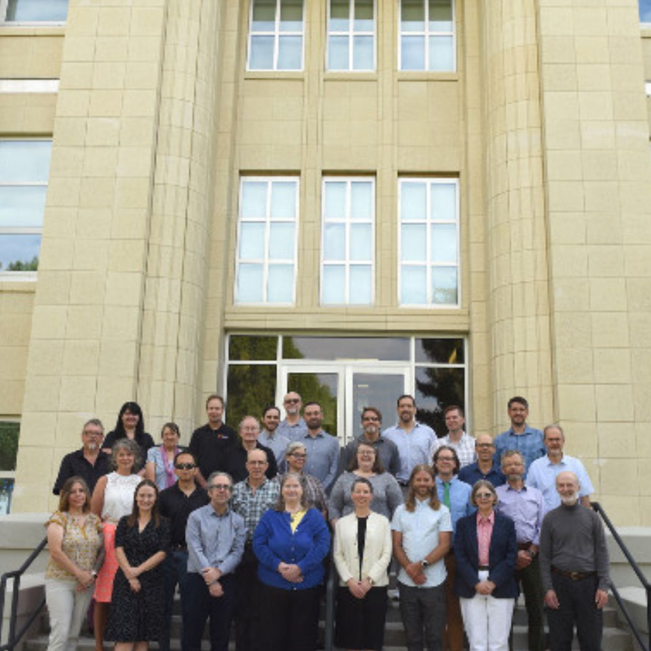 The English and Philosophy faculty pose for a picture on the front steps of the Liberal Arts building