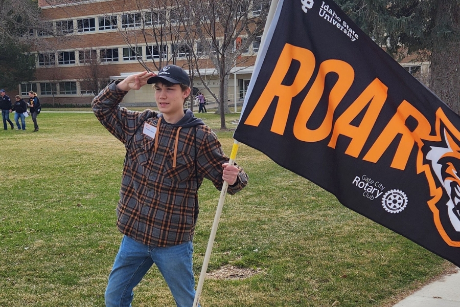 Hawkins holds a Roar flag