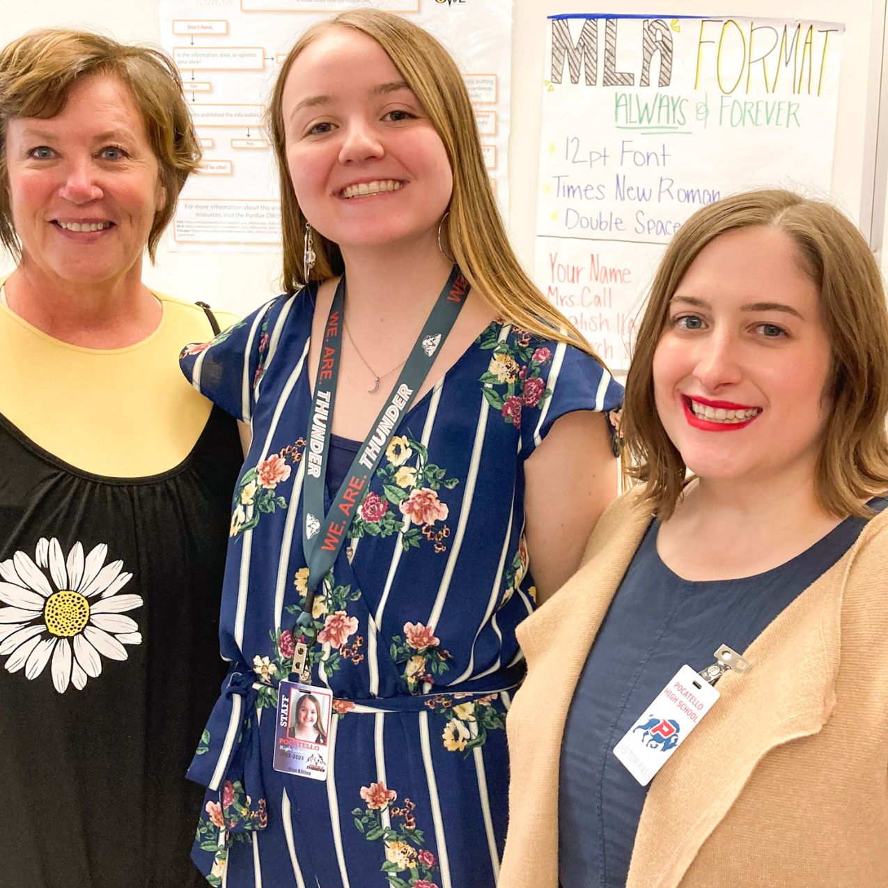 Three teachers stand together smiling for a photo. They are a high school teacher at Pocatello High School, a student teacher from the ISU program, and a professor of history at ISU