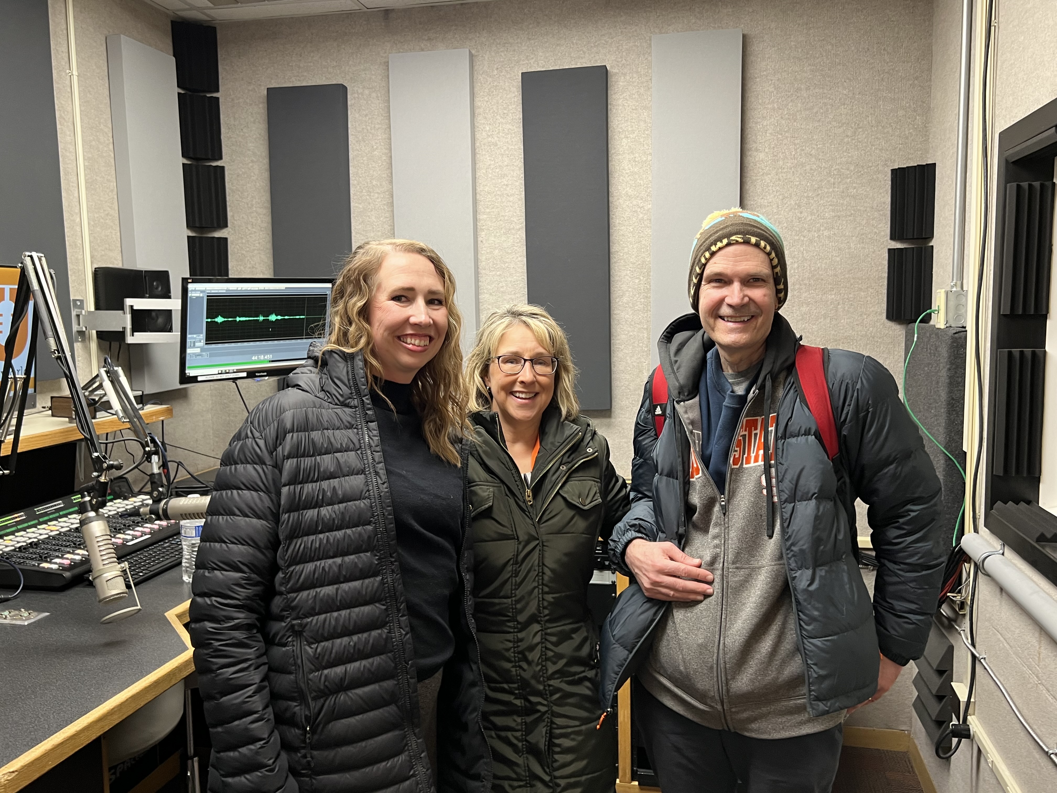 Kandi Turley Ames, Whitney Fenwick, and Mark McBeth standing in the ISU KISU studio recording room