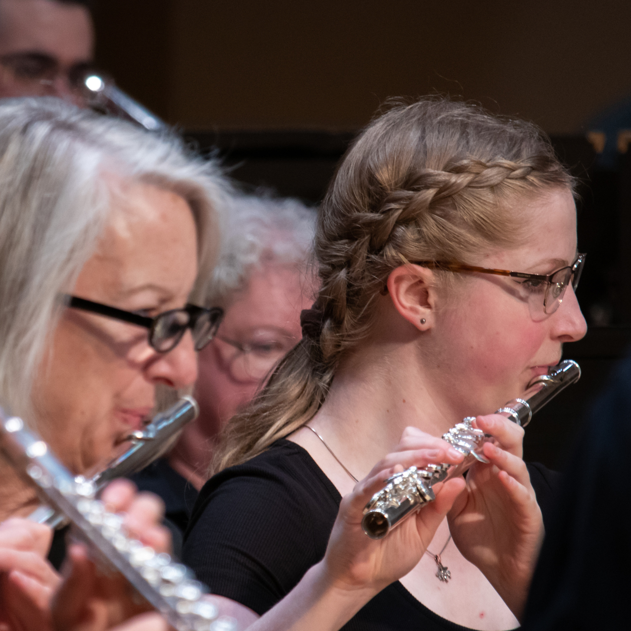 ISU band members of the flute section play their flutes at a performance