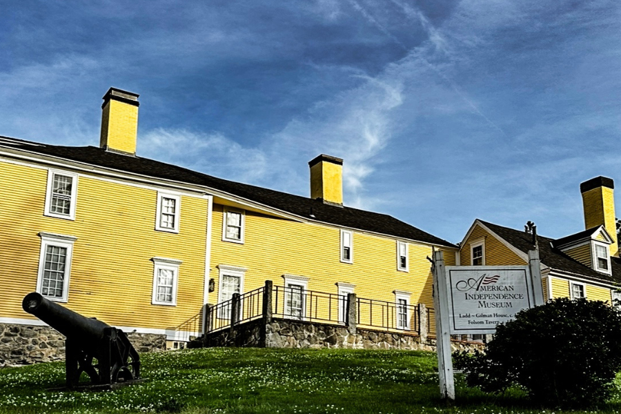 The front of the American Independence Museum. It is a yellow building.