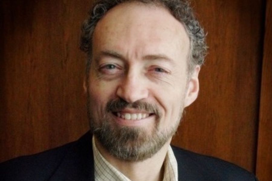 Headshot of Dr. Randy Clemons. He is smiling and wearing a suit and tie.