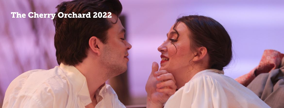 The Cherry Orchard, 2022, a young man cups a woman's chin in his hand. They gaze at each other rapturously.