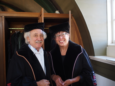 Two academics in robes and caps