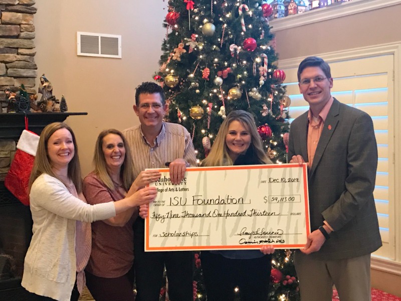 Friends of Bryce Lloyd present Arts and Letters development director Matt Stucki with a check to fund student scholarships.