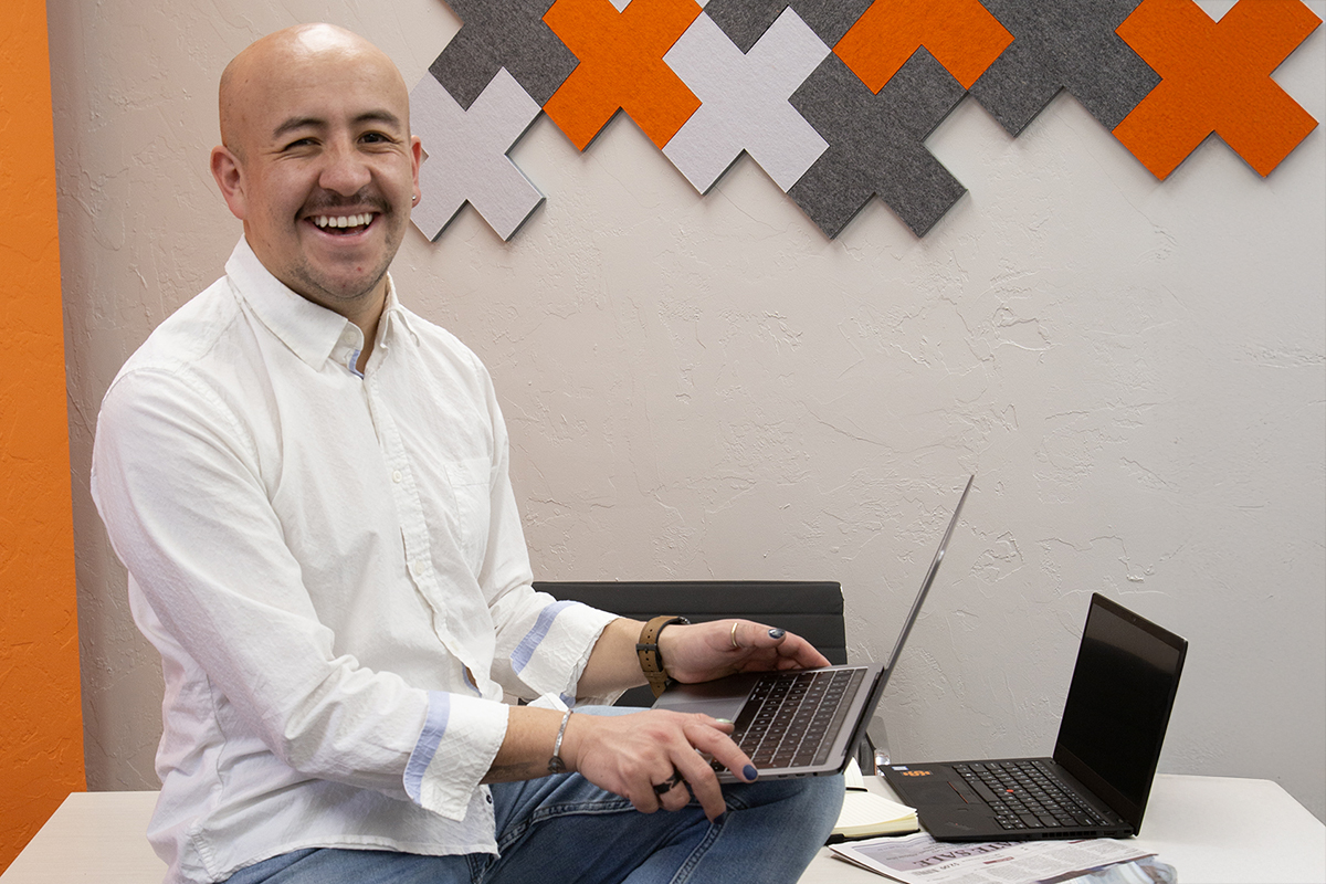 MBA graduate student smiling while holding laptop