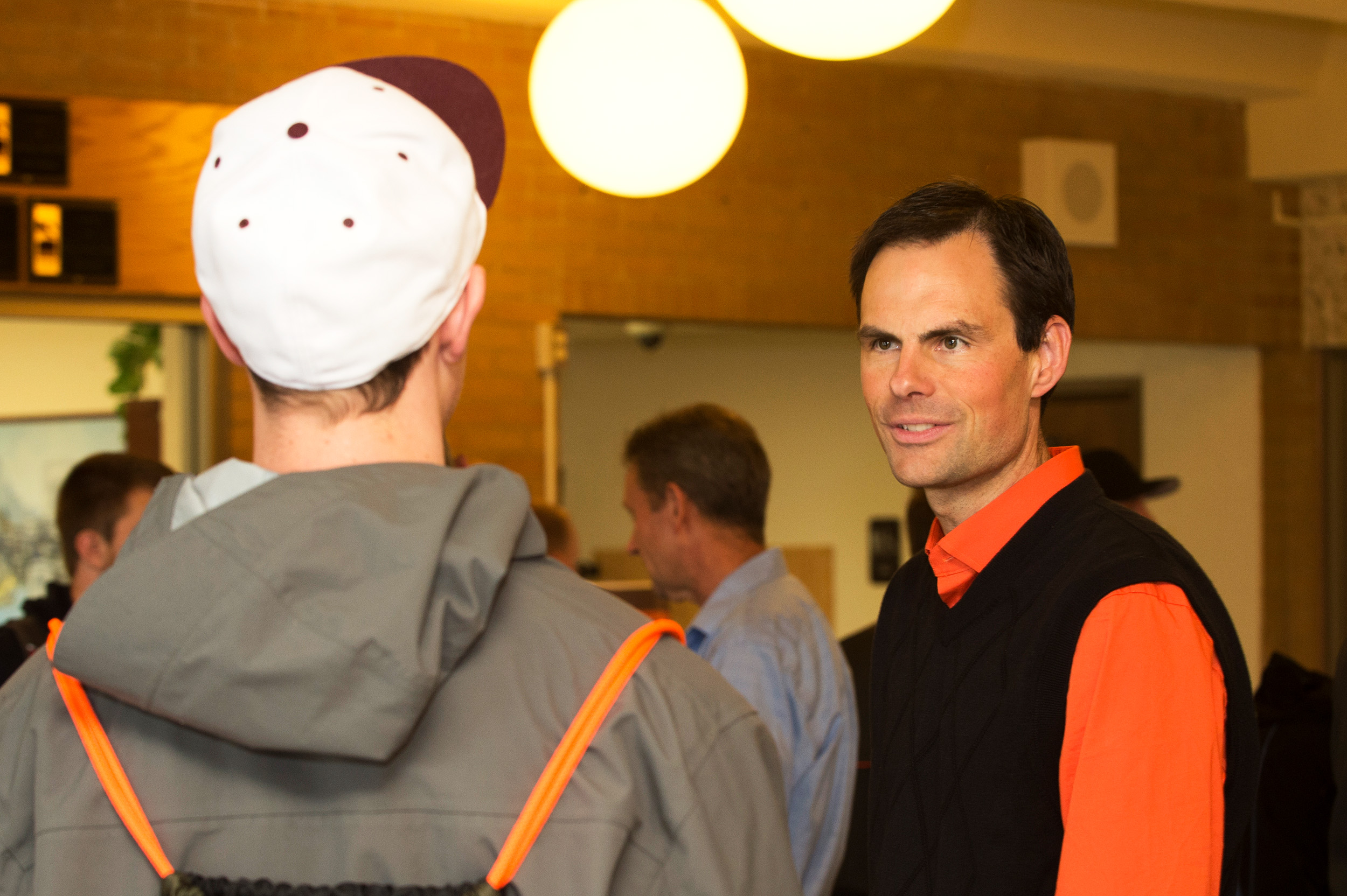 A professor talking to a student at an event