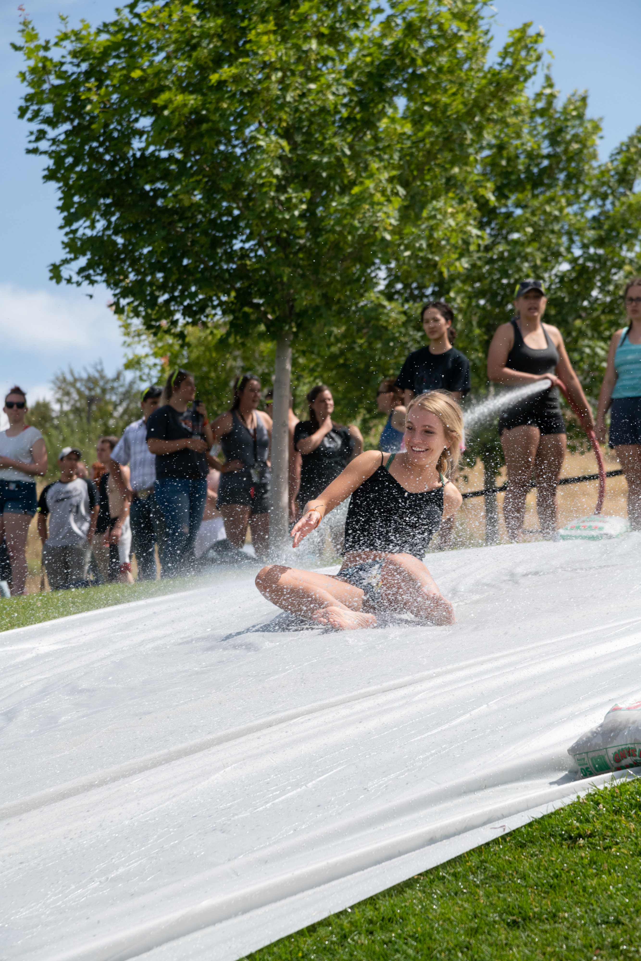 Students sliding down a slip and slide