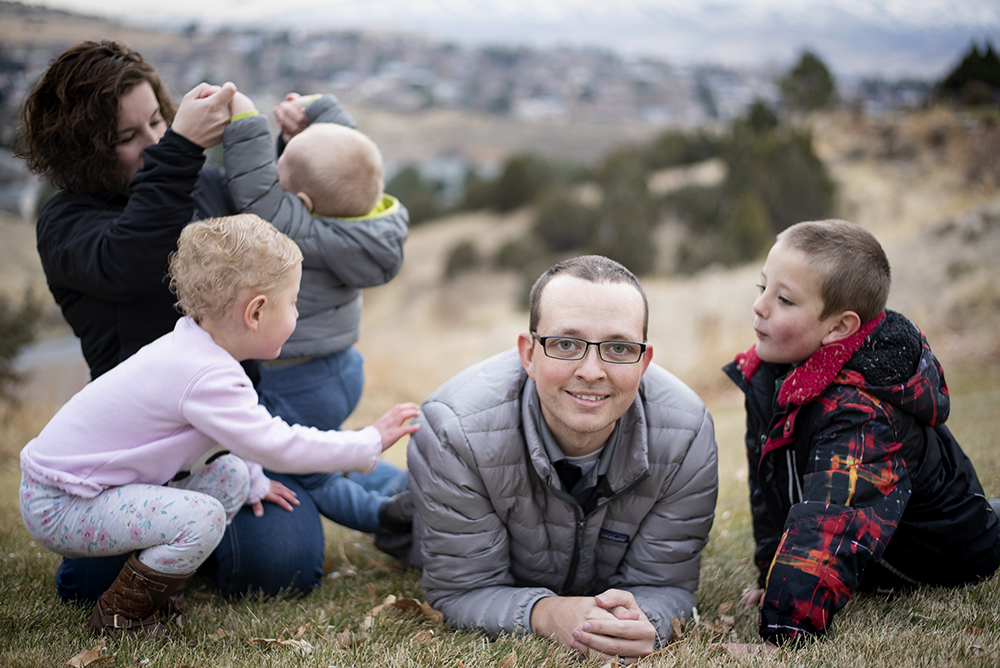 Student sitting on the ground with his family