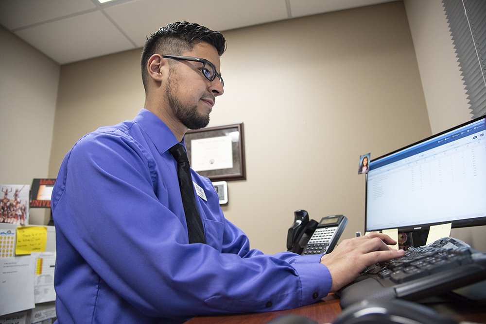 Man typing on a computer keyboard