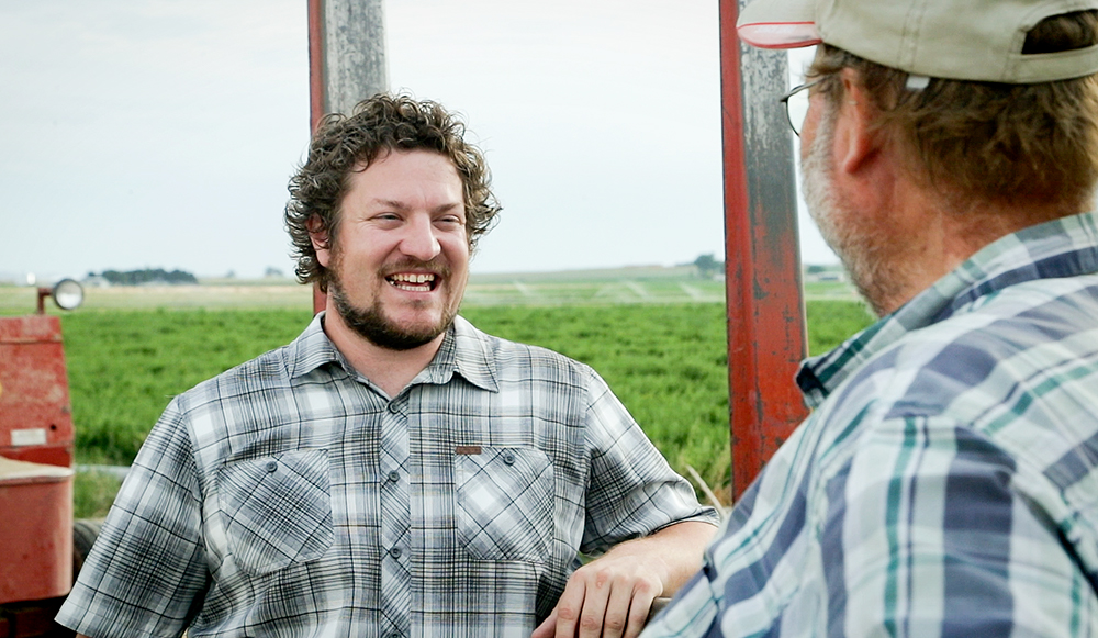 Student talking with a farmer