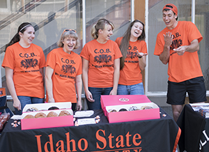 Students handing out doughnuts